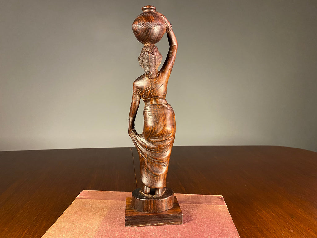 Carved Wooden Figure of a Woman Carrying a Vessel