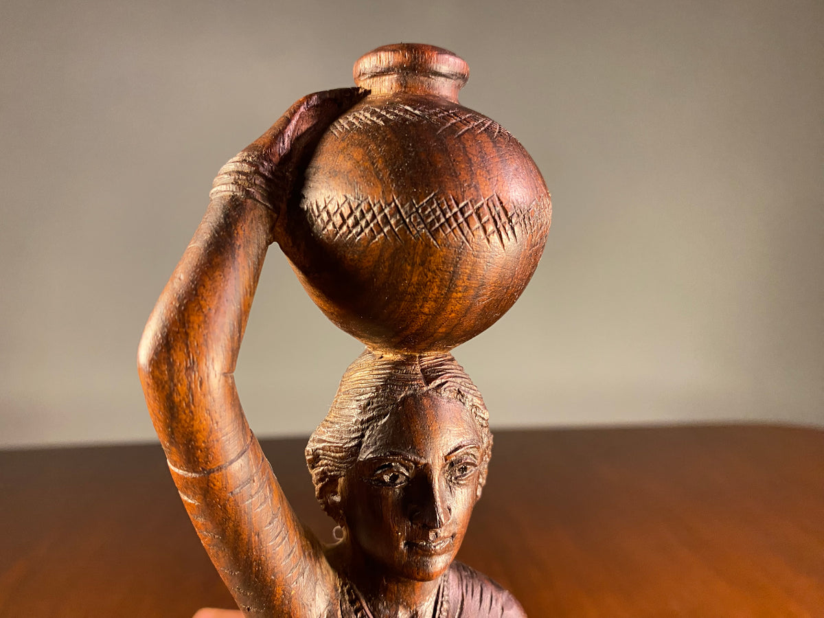 Carved Wooden Figure of a Woman Carrying a Vessel