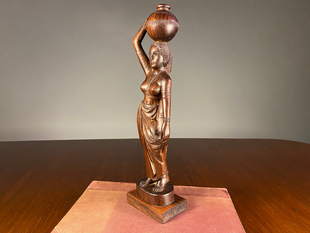 Carved Wooden Figure of a Woman Carrying a Vessel