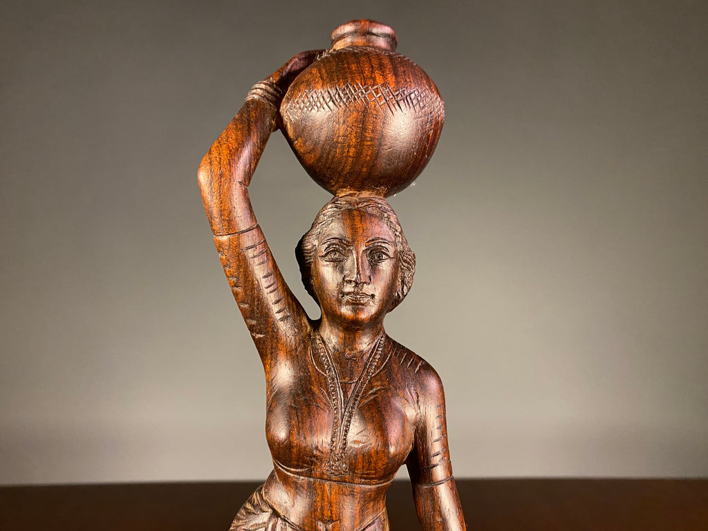 Carved Wooden Figure of a Woman Carrying a Vessel