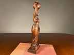 Carved Wooden Figure of a Woman Carrying a Vessel