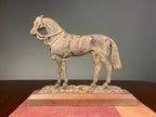 Vintage cast-iron horse ornament mounted on a wooden plinth