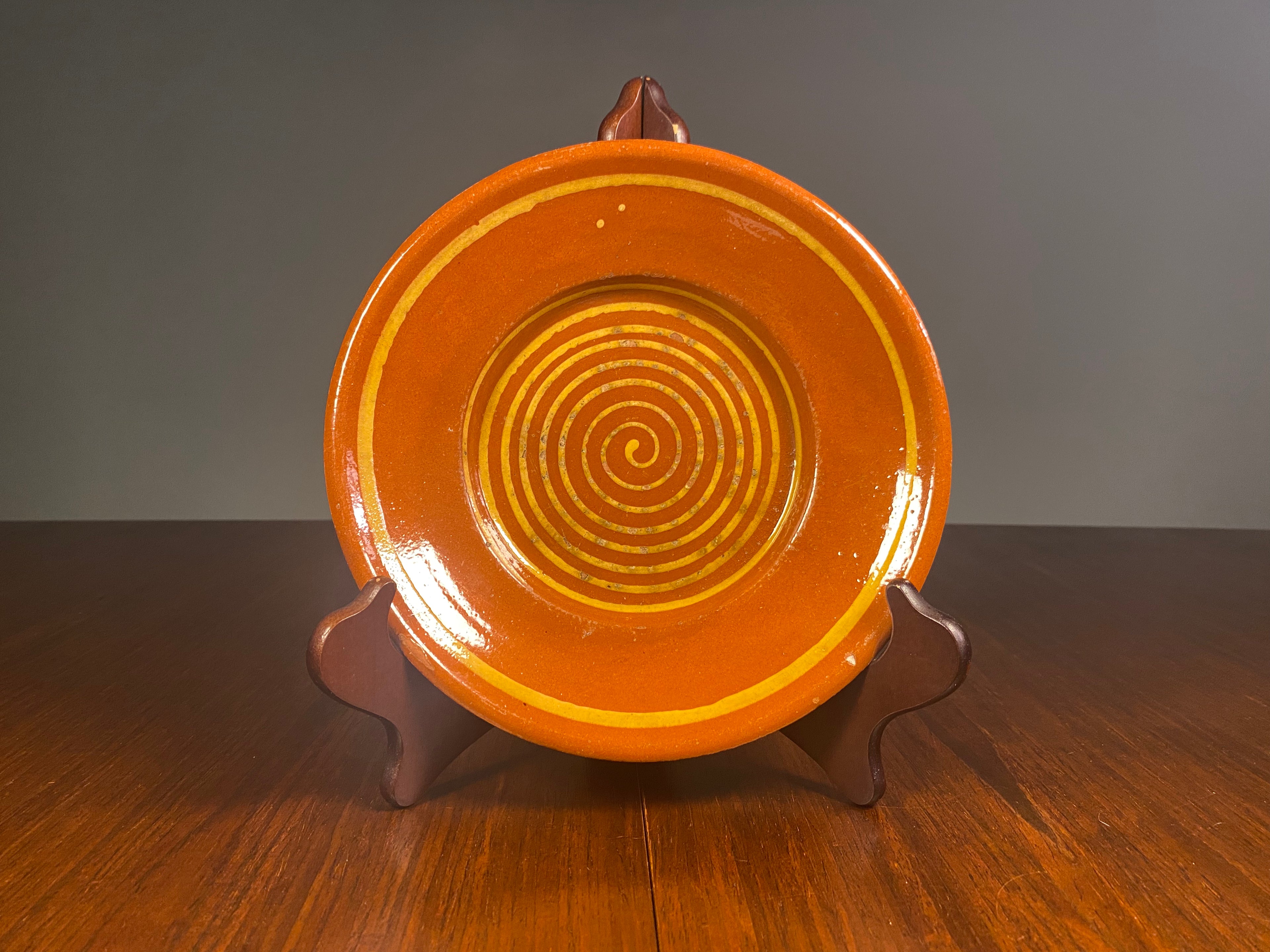 Vintage English terracotta slipware plate with yellow concentric rings