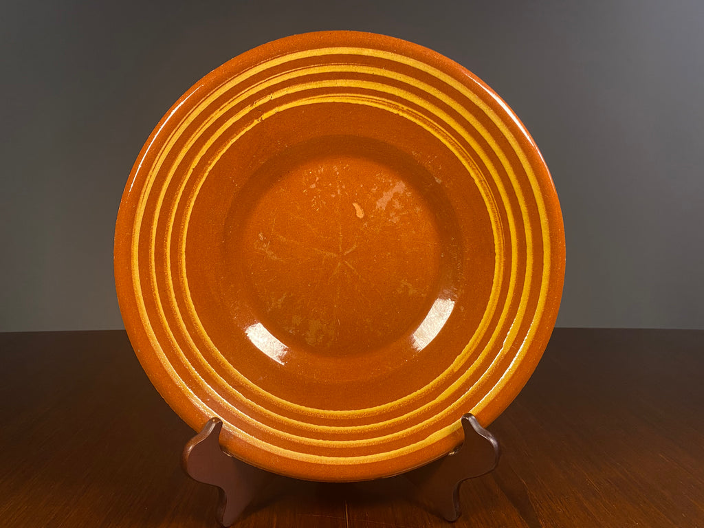 Large vintage English terracotta slipware plate with yellow concentric decoration