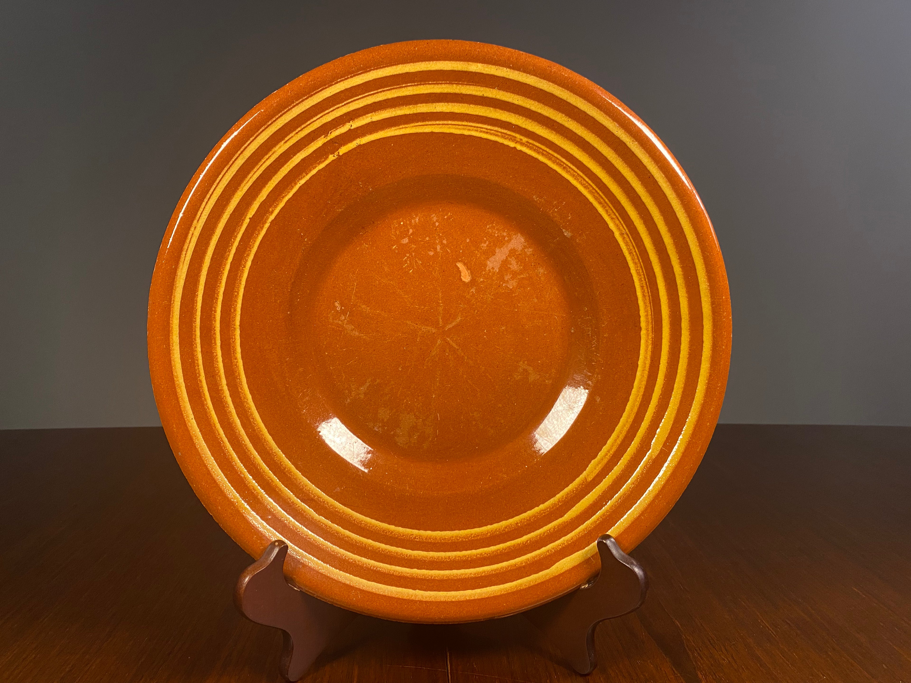 Large vintage English terracotta slipware plate with yellow concentric decoration
